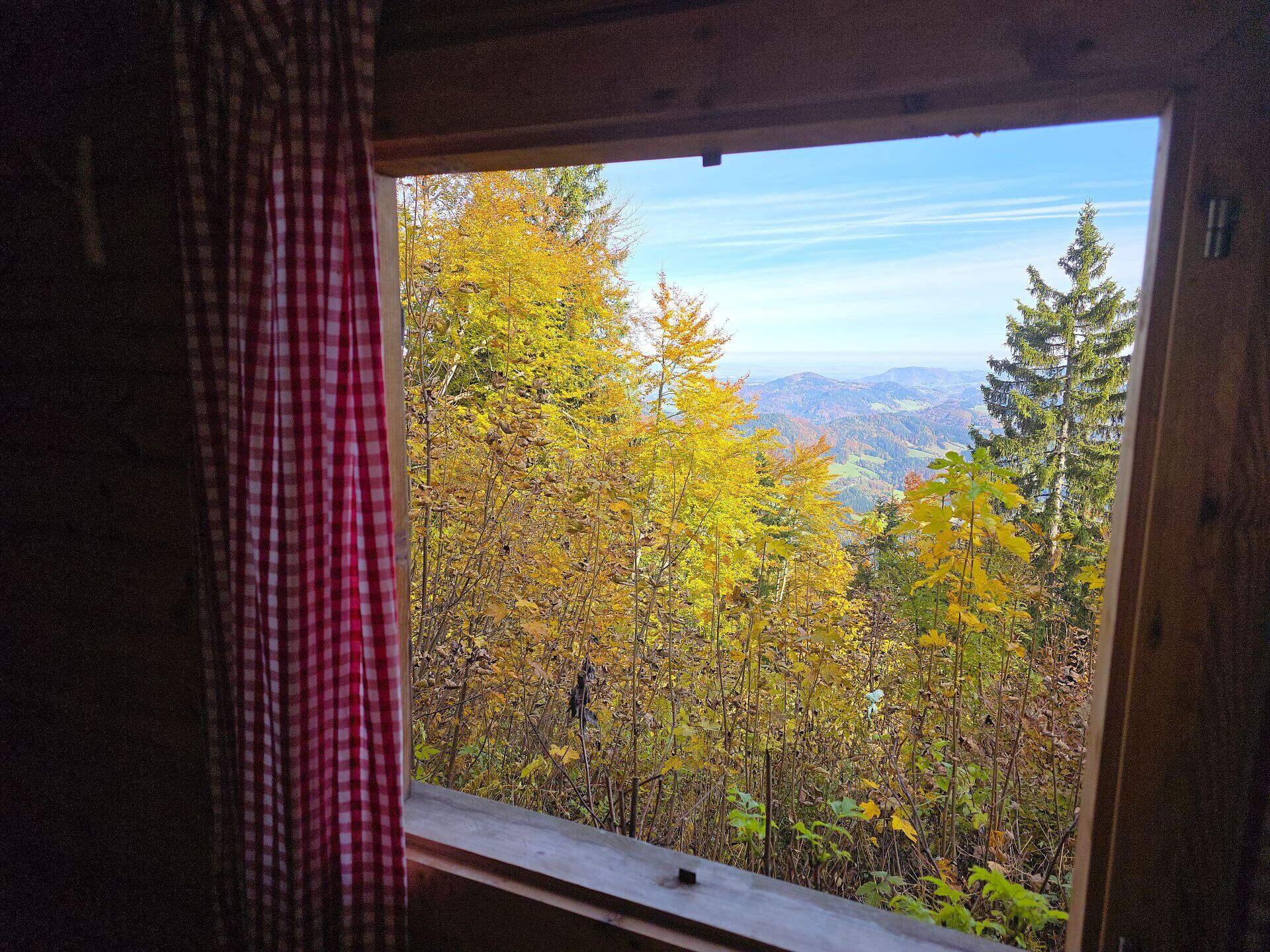 Blick vom Fenster der Abenteuer-Hütte im Mostviertel auf die umliegende Bergwelt.