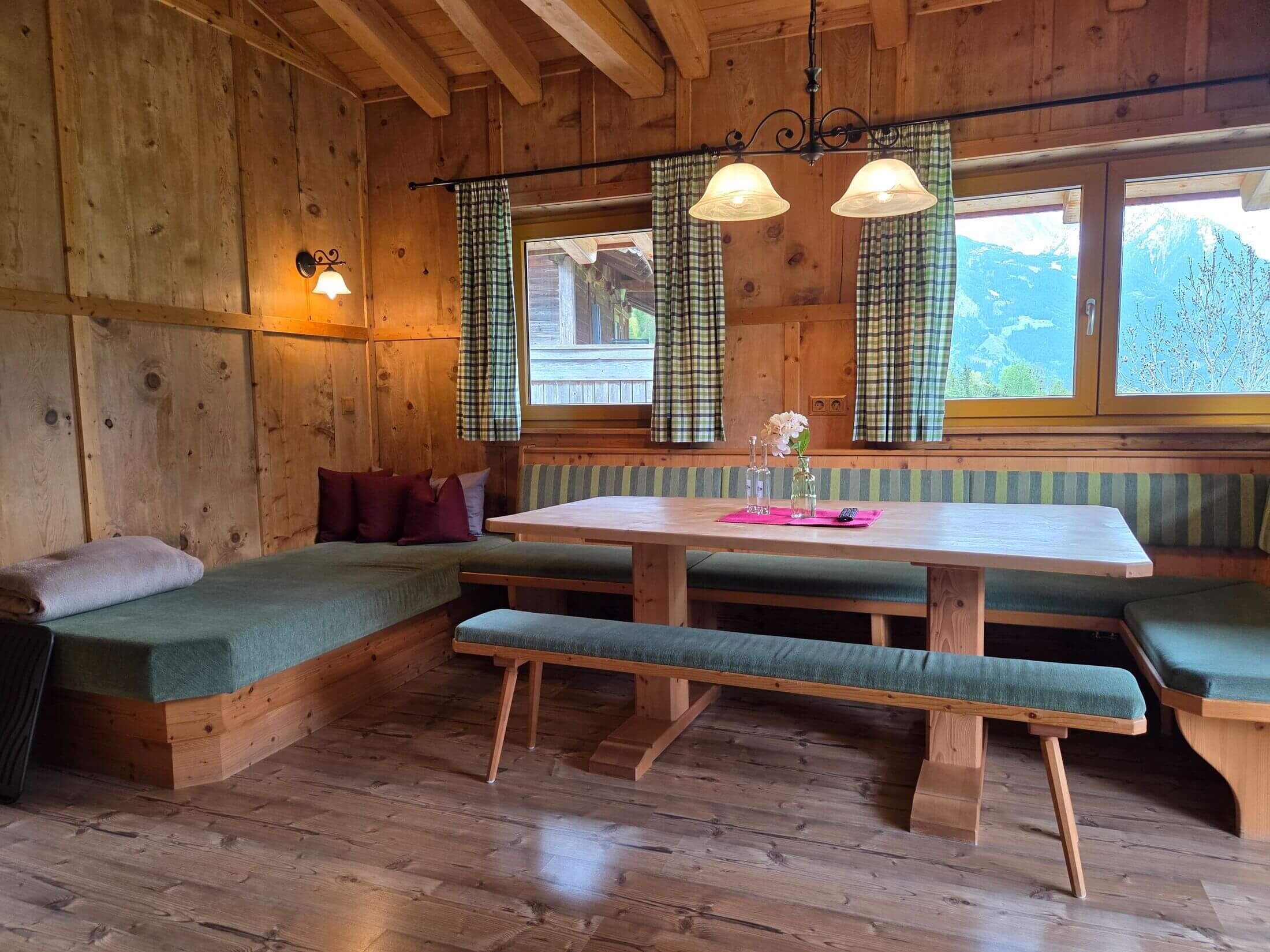 Die Sitzgelegenheit in der alten Brennhütte im Zillertal ist gemütlich und großzügig.